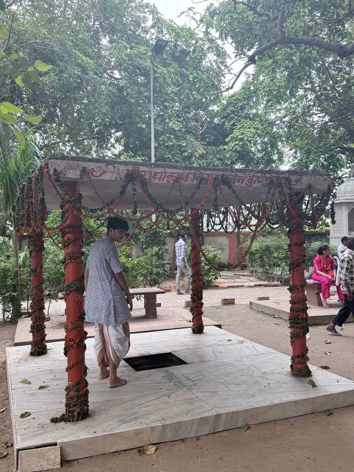 Garlanded pavilion with red pillars over a small kund at Bhandir Van, the place of Radha Krishna vivah in Braj tradition