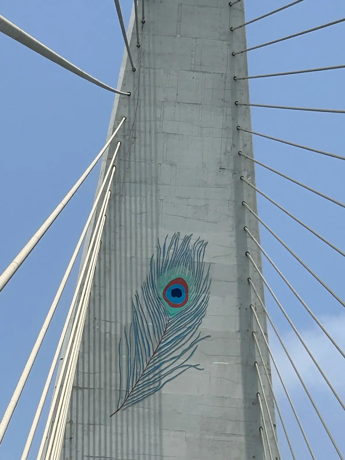 Peacock feather artwork painted on a bridge pylon in Dwarka, a symbol of Lord Krishna
