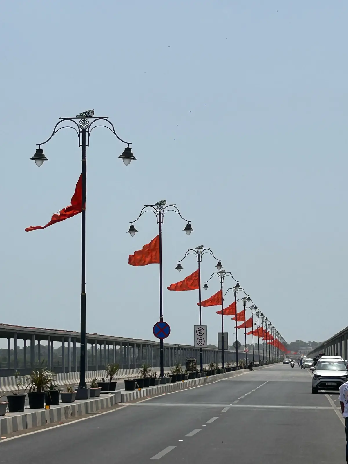 Bridge road in Dwarka lined with saffron flags and ornate lamp posts