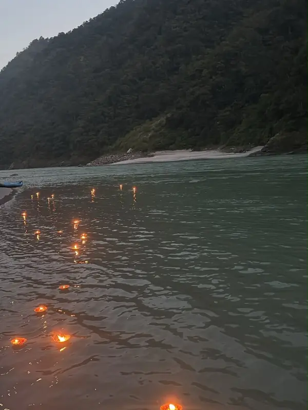 Lamps floating on the Ganga at dusk after a private group aarti in Rishikesh