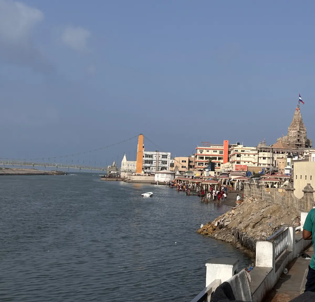 Gomti Ghat on the riverfront in Dwarka with the spire of Dwarkadhish Temple in the distance