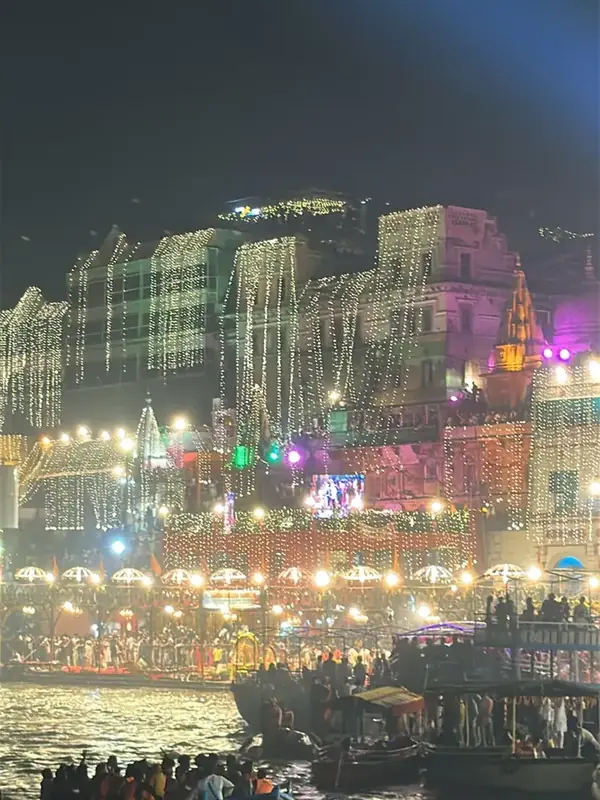 Illuminated ghats of Varanasi at night seen from a boat on the Ganga