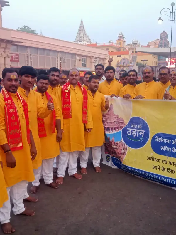 Group of pilgrims in yellow kurtas near Shri Ram Janmabhoomi Mandir in Ayodhya
