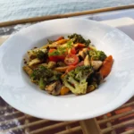 Grilled exotic salad with broccoli, baby corn, mushroom and cherry tomatoes, the water behind, at House of Ullassa Cafe, a pure veg cafe in Chapora