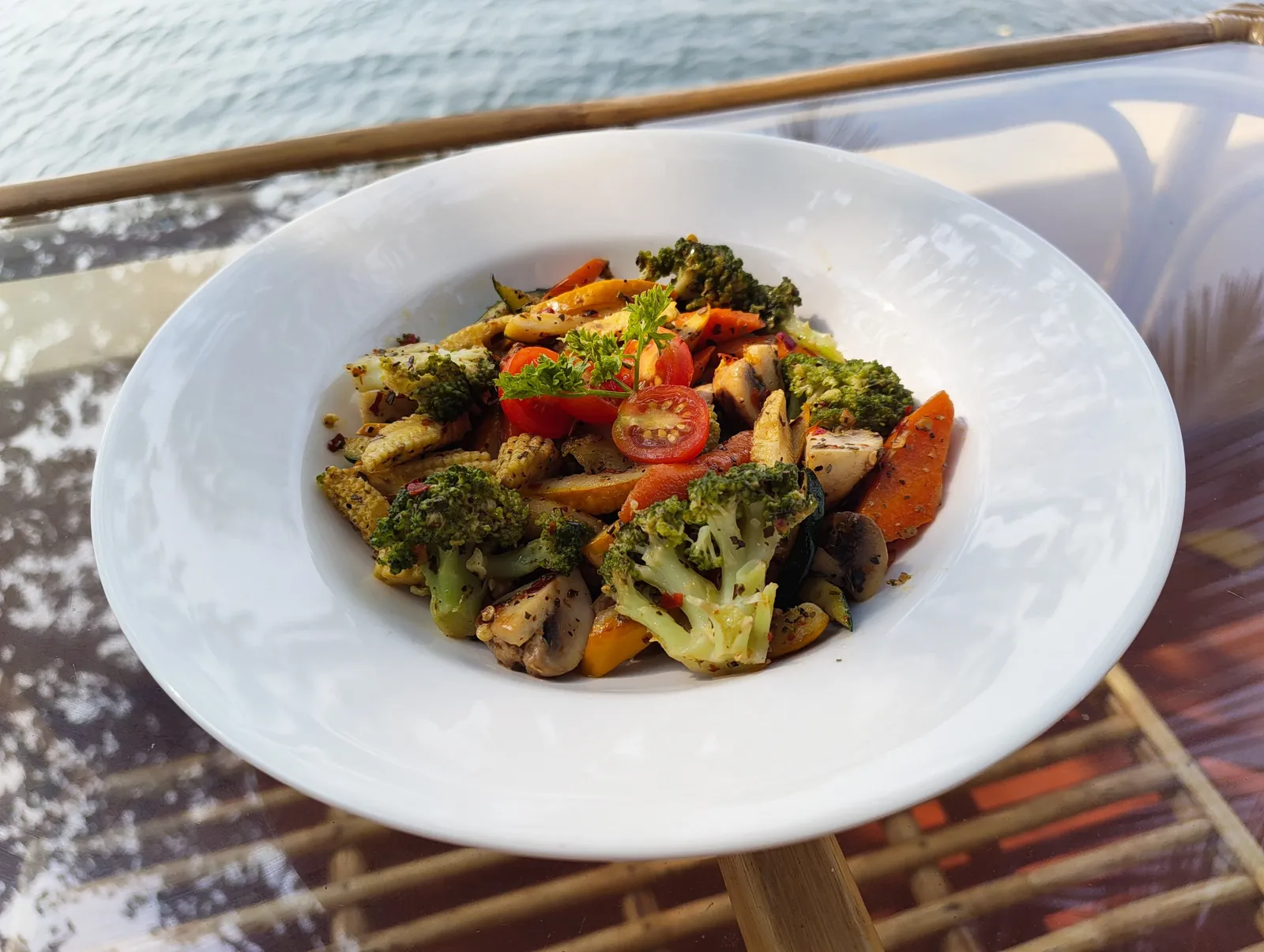 Grilled exotic salad with broccoli, baby corn, mushroom and cherry tomatoes, the water behind, at House of Ullassa Cafe, a pure veg cafe in Chapora